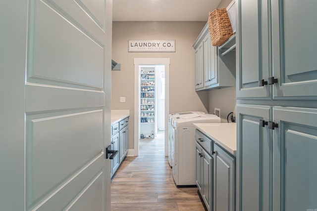 234 Barrett Ln, Cabot, AR 72023 - washroom featuring light wood finished floors, separate washer and dryer, baseboards, and cabinet space