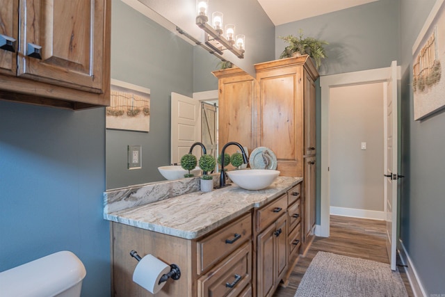 234 Barrett Ln, Cabot, AR 72023 - bathroom with toilet, wood finished floors, vanity, and baseboards