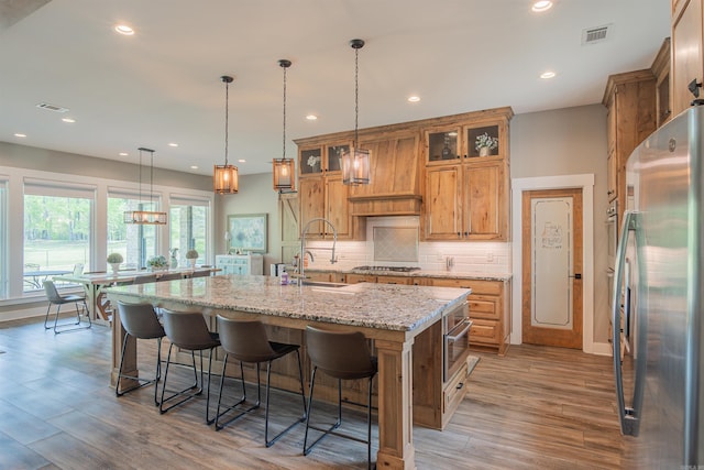 234 Barrett Ln, Cabot, AR 72023 - kitchen featuring a kitchen breakfast bar, visible vents, appliances with stainless steel finishes, a sink, and a center island with sink