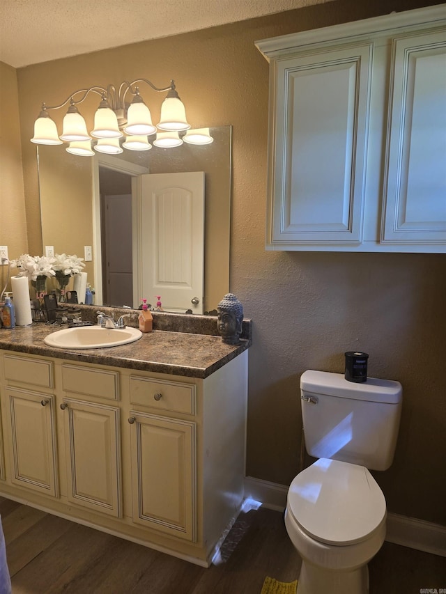 801 Randall Dr, Searcy, AR 72143 - bathroom with toilet, wood finished floors, vanity, and baseboards