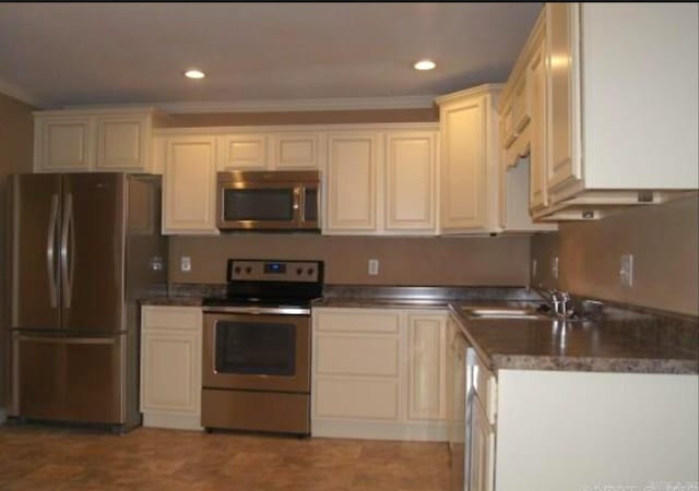 801 Randall Dr, Searcy, AR 72143 - kitchen with a sink, ornamental molding, appliances with stainless steel finishes, and recessed lighting