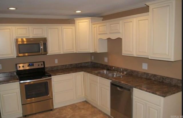 801 Randall Dr, Searcy, AR 72143 - kitchen featuring recessed lighting, dark countertops, a sink, and appliances with stainless steel finishes