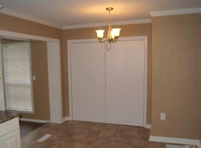 801 Randall Dr, Searcy, AR 72143 - unfurnished dining area featuring a chandelier, crown molding, and baseboards