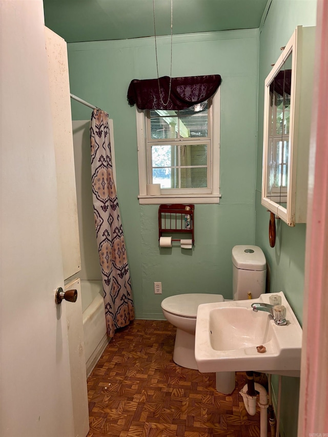 full bathroom with shower / bath combo, a sink, and toilet