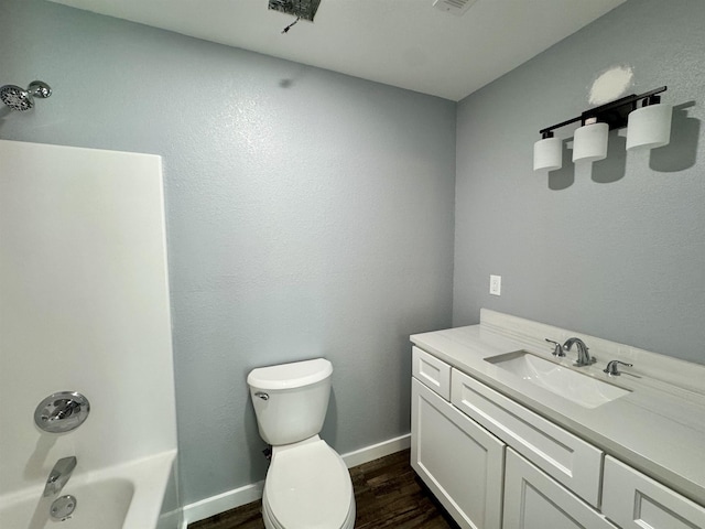 bathroom featuring bathing tub / shower combination, vanity, toilet, wood finished floors, and baseboards