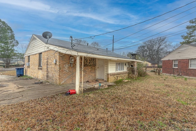 2724 Beatty St, West Memphis, AR 72301 - exterior space with brick siding, cooling unit, and a lawn
