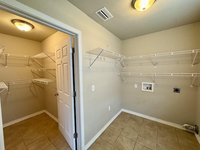 25 Heritage Ln, Melbourne, AR 72556 - laundry area with baseboards, visible vents, washer hookup, tile patterned flooring, and electric dryer hookup