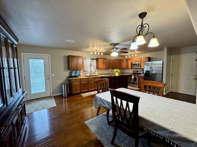 25 Heritage Ln, Melbourne, AR 72556 - dining room featuring ceiling fan with notable chandelier, baseboards, a wealth of natural light, and dark wood-style flooring