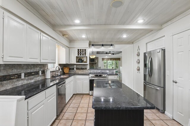 6 Narvaez Way, Hot Springs Village, AR 71909 - kitchen with white cabinets, stainless steel appliances, a sink, tasteful backsplash, and light tile patterned flooring