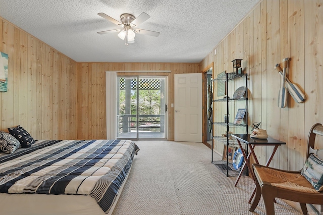 6 Narvaez Way, Hot Springs Village, AR 71909 - carpeted bedroom featuring a ceiling fan, access to exterior, wooden walls, and a textured ceiling