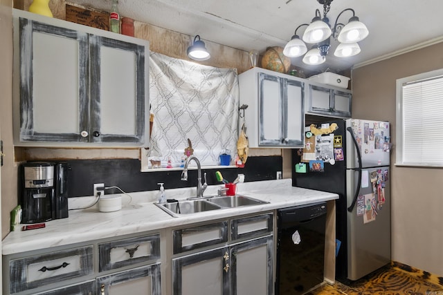 kitchen with freestanding refrigerator, dishwasher, light countertops, and a sink
