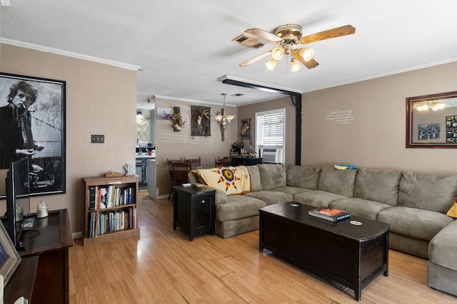 living area with light wood finished floors, cooling unit, ceiling fan, and crown molding