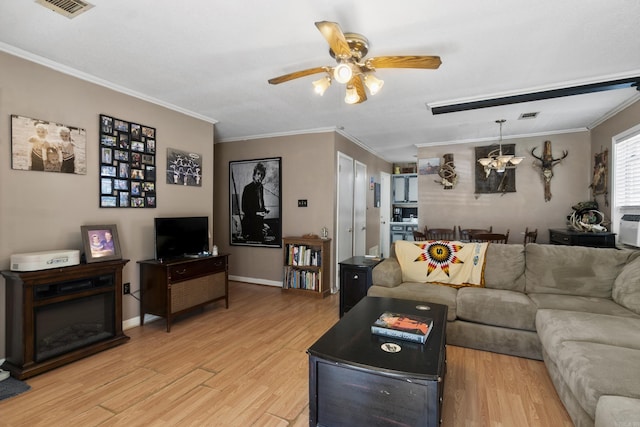 living area featuring ceiling fan, crown molding, and light wood-style floors
