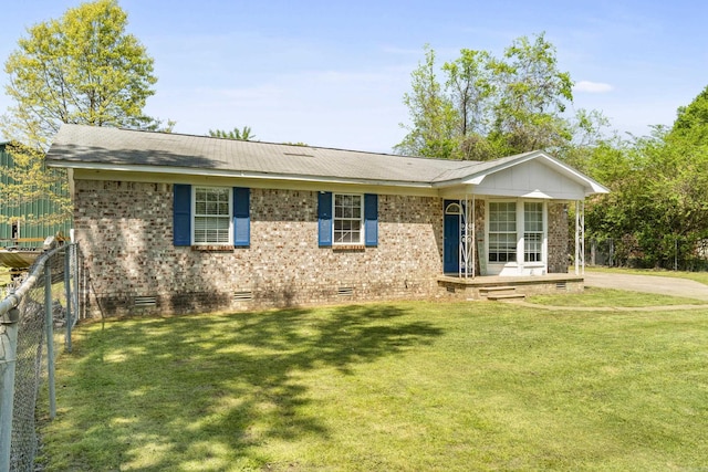 ranch-style home featuring brick siding, a front lawn, crawl space, and fence