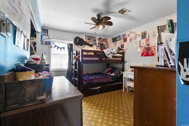 bedroom featuring a ceiling fan, tile patterned floors, a textured ceiling, and visible vents