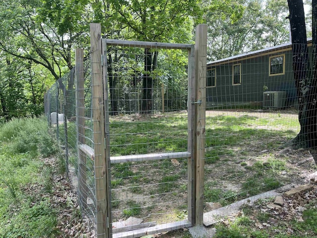 view of yard with fence and central AC unit
