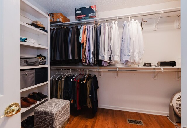 walk in closet with wood finished floors and visible vents