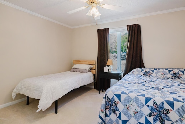 bedroom featuring carpet, a ceiling fan, baseboards, and ornamental molding