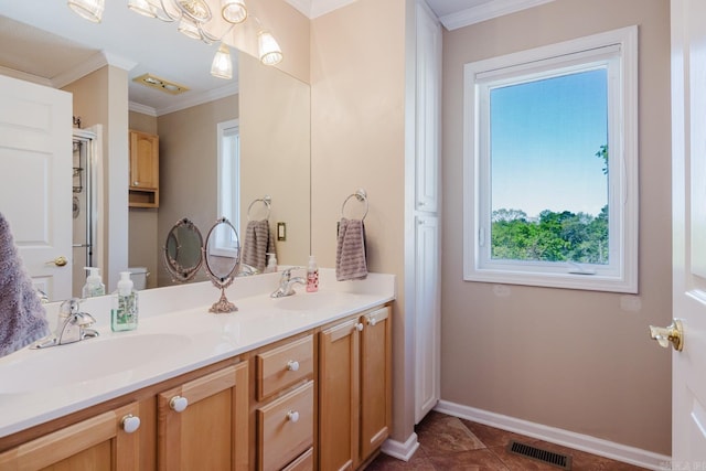 bathroom with visible vents, a sink, double vanity, and crown molding