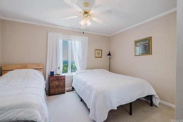 bedroom featuring a ceiling fan, baseboards, crown molding, and carpet