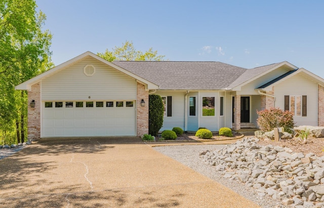 single story home featuring an attached garage, a shingled roof, driveway, and brick siding