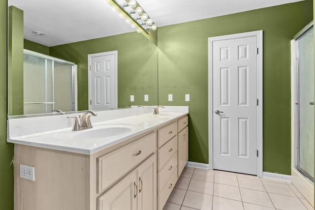 bathroom with tile patterned floors, a sink, double vanity, and a stall shower