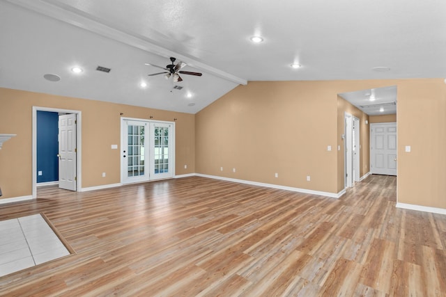 unfurnished living room with light wood-type flooring, vaulted ceiling with beams, visible vents, baseboards, and a ceiling fan
