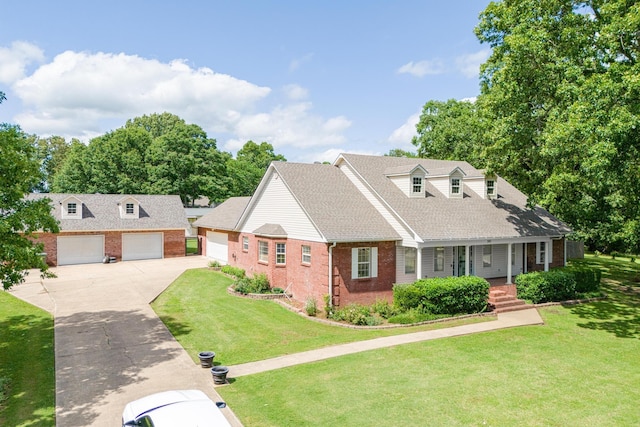 cape cod home featuring a shingled roof, driveway, covered porch, brick siding, and a front yard