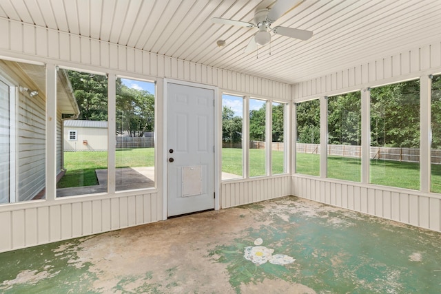 unfurnished sunroom with ceiling fan