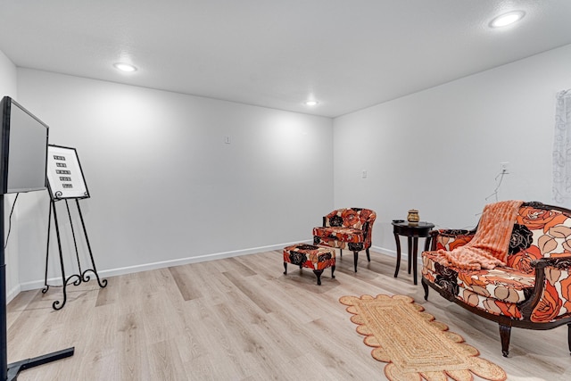 sitting room featuring baseboards, recessed lighting, and light wood-type flooring