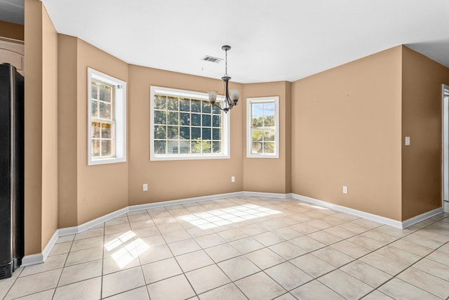 unfurnished dining area featuring visible vents, baseboards, a notable chandelier, and light tile patterned floors
