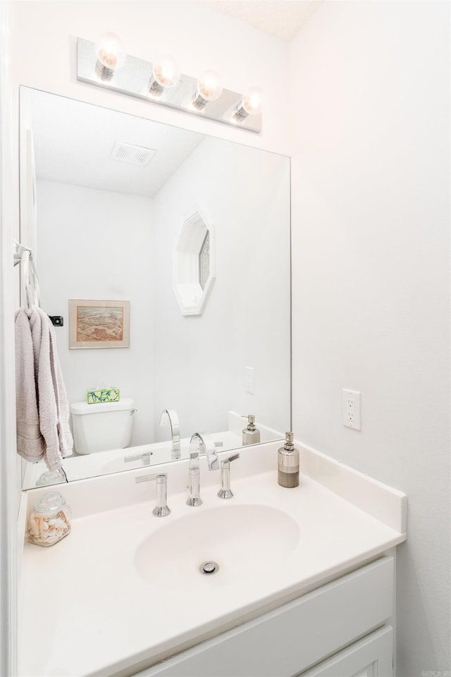 18 Fastota Ln, Hot Springs Village, AR 71909 - bathroom with visible vents, vanity, and toilet