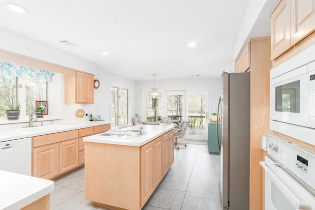 18 Fastota Ln, Hot Springs Village, AR 71909 - kitchen featuring light countertops, light brown cabinets, a sink, white appliances, and a center island