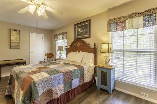 bedroom featuring baseboards, wood finished floors, and ceiling fan