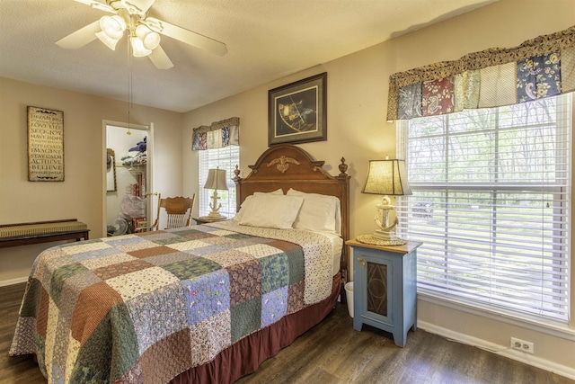 bedroom with baseboards, a ceiling fan, wood finished floors, and multiple windows