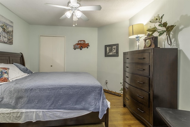 bedroom featuring a ceiling fan and wood finished floors