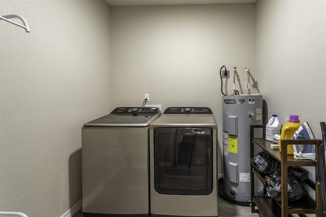 laundry area with washer and dryer, water heater, and laundry area