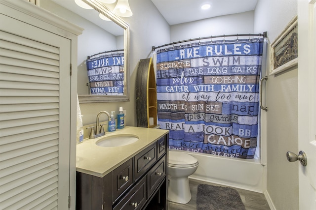 full bathroom with wood finished floors, toilet, vanity, and shower / tub combo with curtain