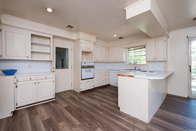 309 Del Rio Dr, Little Rock, AR 72205 - kitchen with dark wood-style floors, open shelves, visible vents, white appliances, and a peninsula