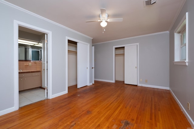309 Del Rio Dr, Little Rock, AR 72205 - unfurnished bedroom with visible vents, ornamental molding, connected bathroom, light wood-type flooring, and baseboards