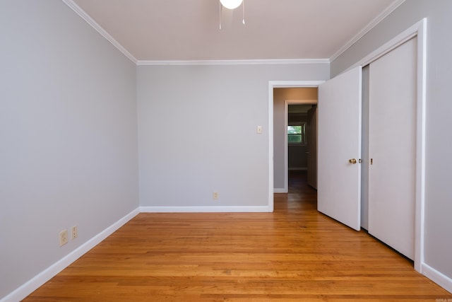 309 Del Rio Dr, Little Rock, AR 72205 - unfurnished bedroom featuring light wood-style floors, a closet, baseboards, and ornamental molding