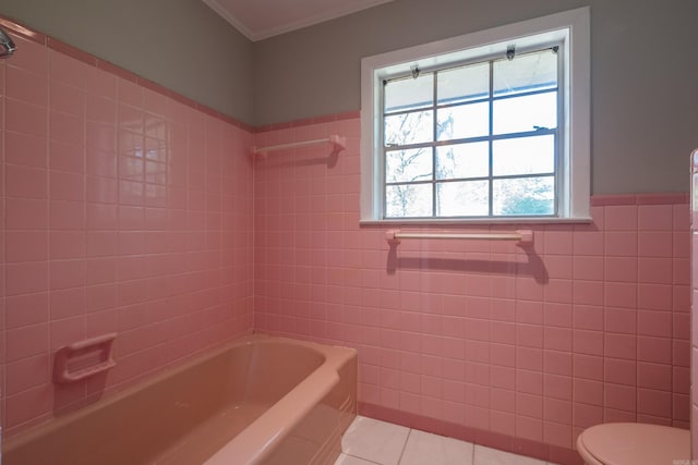 309 Del Rio Dr, Little Rock, AR 72205 - bathroom with toilet, tile patterned flooring, washtub / shower combination, and tile walls
