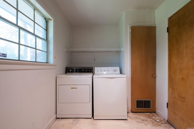 309 Del Rio Dr, Little Rock, AR 72205 - clothes washing area with baseboards, visible vents, washer and clothes dryer, and laundry area
