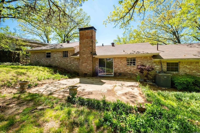309 Del Rio Dr, Little Rock, AR 72205 - rear view of house featuring a chimney, central AC unit, brick siding, and a patio