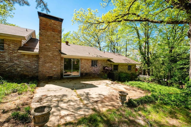 309 Del Rio Dr, Little Rock, AR 72205 - rear view of property with a chimney, brick siding, and a patio
