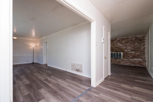 309 Del Rio Dr, Little Rock, AR 72205 - interior space featuring brick wall, baseboards, visible vents, and dark wood-style flooring