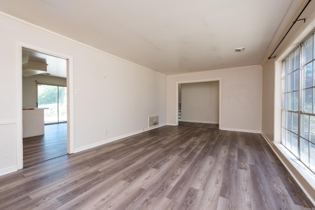 309 Del Rio Dr, Little Rock, AR 72205 - empty room with baseboards, crown molding, dark wood-type flooring, and visible vents
