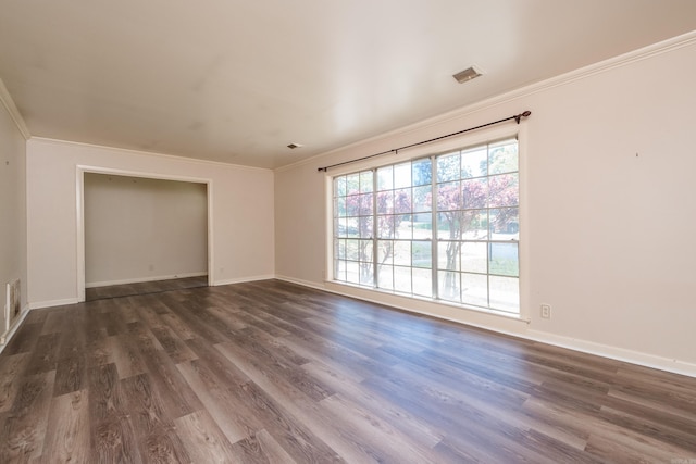 309 Del Rio Dr, Little Rock, AR 72205 - empty room featuring baseboards, ornamental molding, dark wood-type flooring, and visible vents
