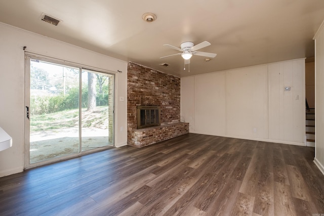 309 Del Rio Dr, Little Rock, AR 72205 - unfurnished living room featuring dark wood finished floors, visible vents, a brick fireplace, and ceiling fan