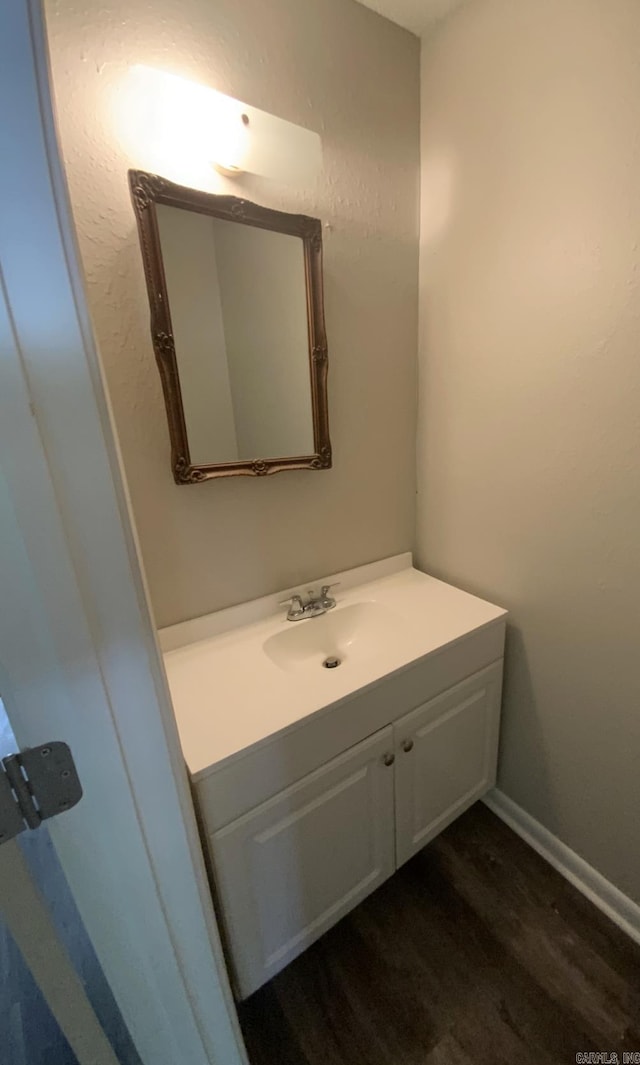 bathroom with wood finished floors and vanity